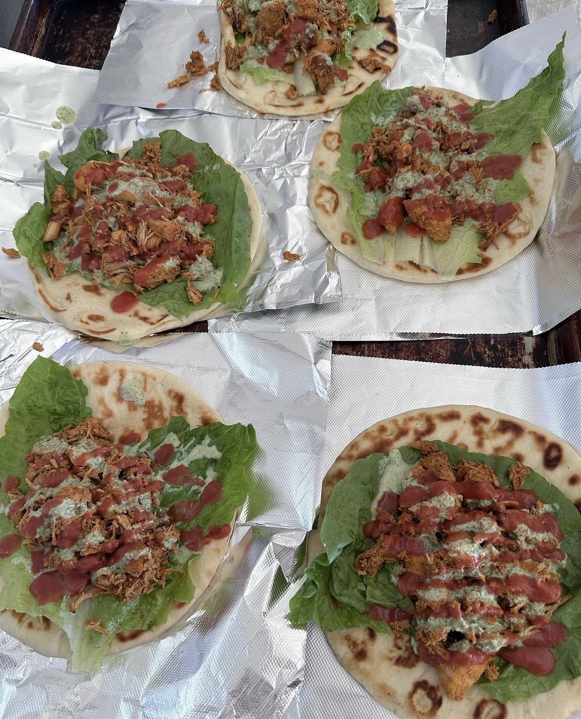 Fresh chicken tikka wraps with mint chutney and lettuce on hand-pulled naan